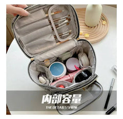 Open Hello Kitty makeup bag showing organized compartments with makeup brushes and cosmetics inside