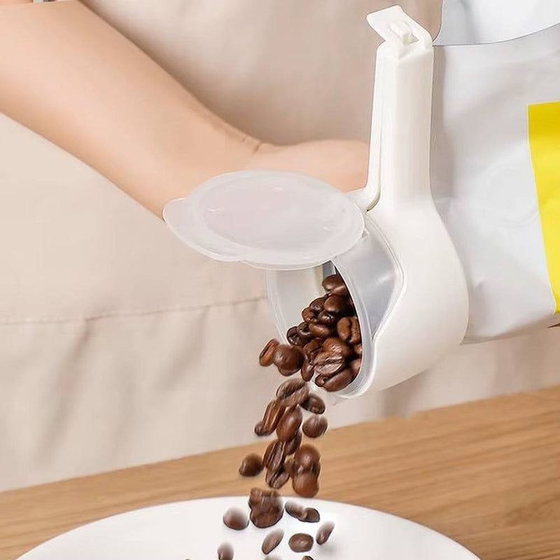 White Food Sealing Clip with Pour Spout pouring coffee beans into a white bowl on wooden surface