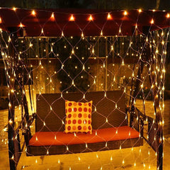 Net mesh solar fairy lights draped over outdoor swing creating a warm, glowing ambiance at night