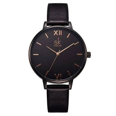 Shengke Fashion Watch for Women with black leather strap and minimalist black dial with rose gold Roman numerals and markers