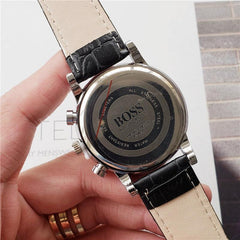Back view of men's quartz high quality watch with black imitation leather strap and stainless steel case
