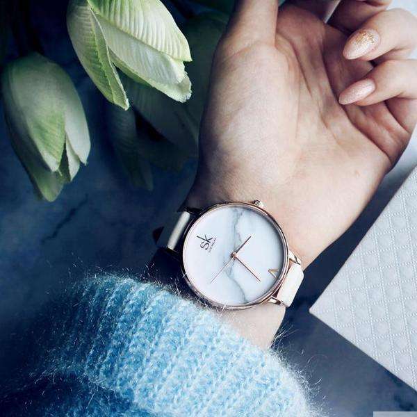 Shengke Fashion Watch for Women with marble dial and white strap, minimalist design and rose gold accents on wrist