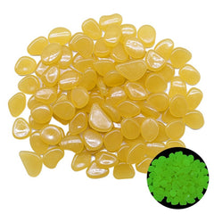 Yellow glow in the dark garden pebbles made from durable resin, glowing green at night, perfect for outdoor decoration and aquariums.