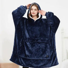 Woman wearing a navy plush heated hoodie blanket with oversized fit and large front pocket