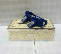Blue Lazy Periscope Horizontal Reading Glasses resting on a decorative box with reflective lenses for comfortable hands-free reading while lying flat