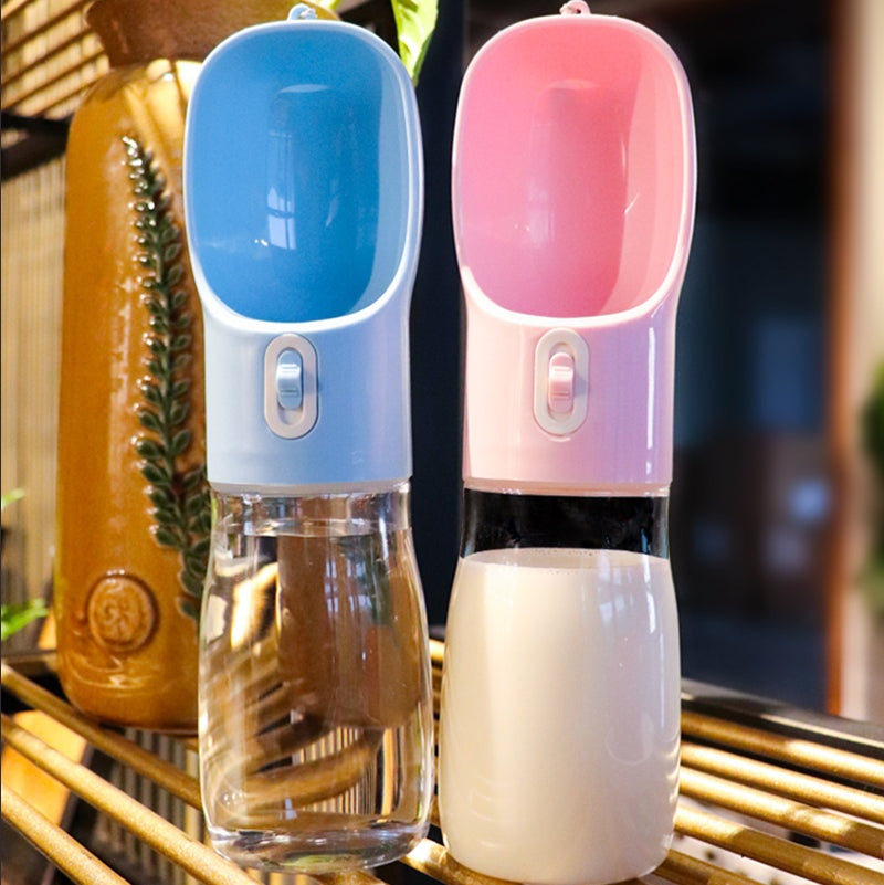 Dual-purpose pet dog water bottle feeder in blue and pink with built-in bowls for easy drinking and snacking on the go