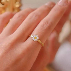 Fidget Spinner Rotatable Ring for women with gold metal band and flower-shaped spinner centerpiece on finger