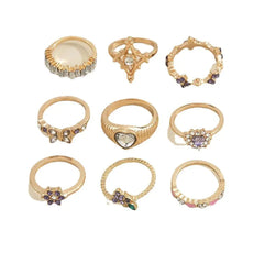 Collection of gold rings with purple diamond grape flower geometric designs and various shapes
