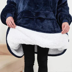 Person wearing a navy blue heated hoodie blanket showing its white plush fleece interior, highlighting its warmth and softness.