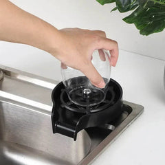 High pressure cup washer made of black ABS plastic installed on kitchen sink for automatic cup cleaning