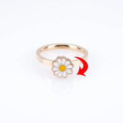 Gold metal Fidget Spinner Rotatable Ring with white and yellow flower design on a white background