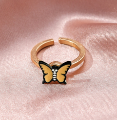 Gold metal fidget spinner rotatable ring for women with butterfly design on pink satin background