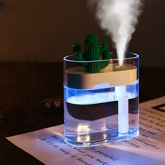 Compact ultrasonic air humidifier with cactus design emitting fine mist for indoor air moisture and comfort