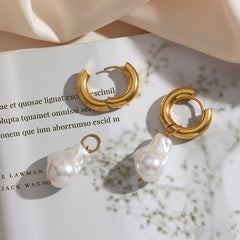 Water Drop Earrings with chunky gold hoops and removable baroque-style pearl charms on a white book background.