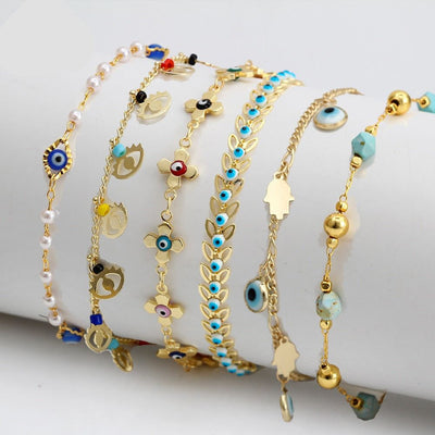 Set of stylish charm bracelets with gold chains, pearls, and colorful natural stone beads