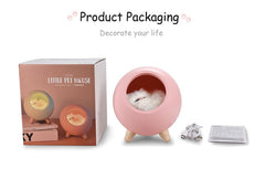 Pink LED cat-shaped light with wooden legs, USB charging cable, and packaging box displayed on white background