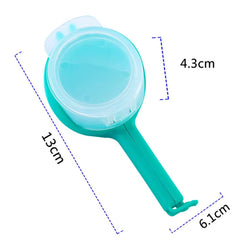 Blue plastic food sealing clip with pour spout measuring 13cm by 6.1cm by 4.3cm