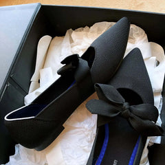 Black flat casual boat shoes with bow detail in a gift box