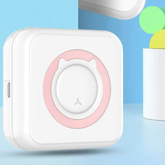 Compact white mini portable thermal sticker printer with pink circular design on front, designed for instant printing and labeling on the go