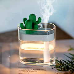 Compact ultrasonic air humidifier with cactus design releasing fine mist in a transparent water tank for healthy, quiet air moisture.