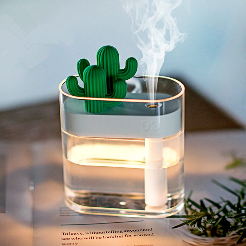 Compact ultrasonic air humidifier with cactus design releasing fine mist in a transparent water tank for healthy, quiet air moisture.
