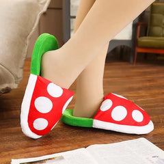 Multifunctional Mushroom Piranha Plush designed as cozy red and white polka dot slippers with green accents on wooden floor.