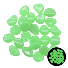 Glow in the dark green garden pebbles glowing brightly at night, perfect for outdoor decoration and aquariums.