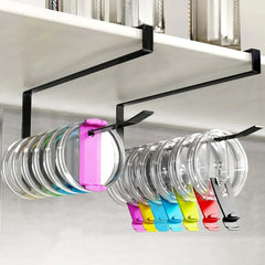Under-shelf black iron lid organizer rack holding various colorful pot lids neatly in kitchen cabinet