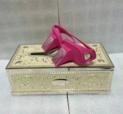 Pink Lazy Periscope Horizontal Reading Glasses resting on an ornate tissue box