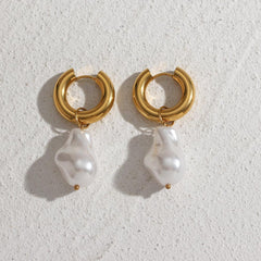 Chunky gold hoop water drop earrings with removable irregular pearl charms on a textured white surface