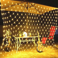 Net Mesh Solar Fairy Lights creating a warm, glowing net curtain effect for outdoor patio decoration at night