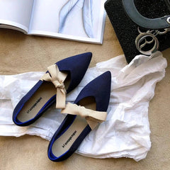 Flat casual boat shoes in royal blue fabric with beige bow detail and pointed toe design